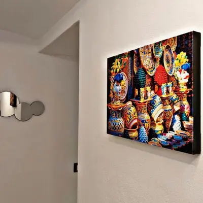 a painting of vases hanging on a wall at Palermo Holiday Room in Palermo