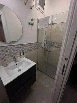 a bathroom with a sink and a shower at Palermo Holiday Room in Palermo