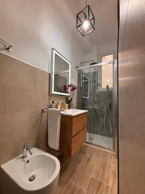 a bathroom with a sink and a shower at Garzilli Cozy Apartment in Palermo