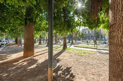 a park with trees and a pole in the middle at Casa Lolli by Wonderful Italy in Palermo