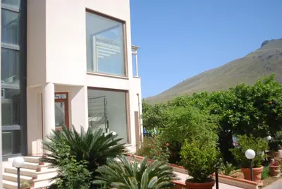 a building with a mountain in the background at Dolce Siesta in Castelluzzo