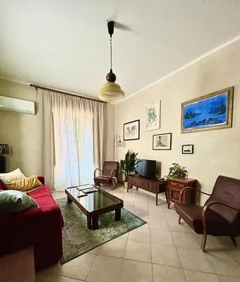 a living room with a couch and a table at Fajra house in Palermo