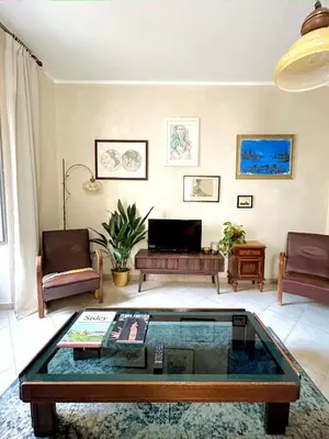 a living room with a couch and a table at Fajra house in Palermo