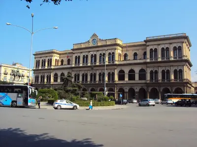 a large building with cars parked in front of it at bonito apartment2 in Palermo