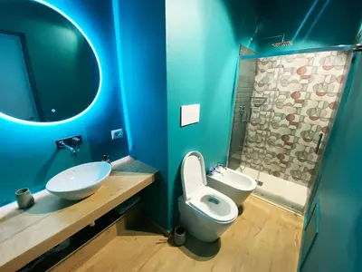 a blue bathroom with a toilet and a sink at bonito apartment2 in Palermo
