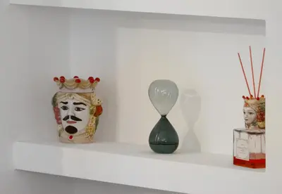 a shelf with vases and a spoon on it at bonito apartment in Palermo