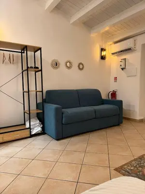 a blue couch sitting in a living room at bonito apartment in Palermo