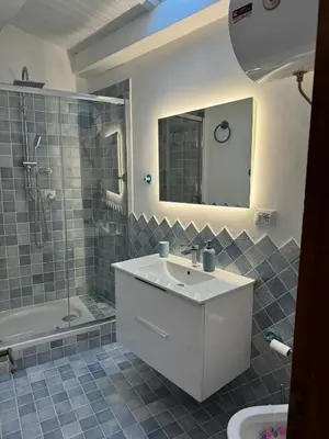 a bathroom with a sink and a shower and a mirror at bonito apartment in Palermo