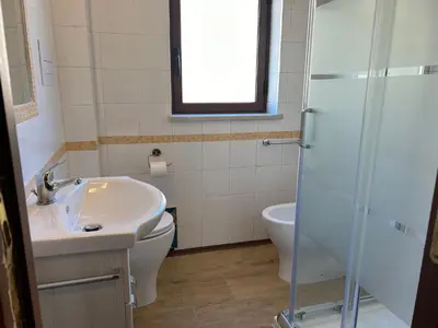 a bathroom with a sink and a toilet and a shower at Glicine House in Palermo