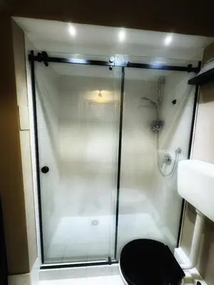 a shower with a glass door in a bathroom at Allalbergheria Apartment in Palermo