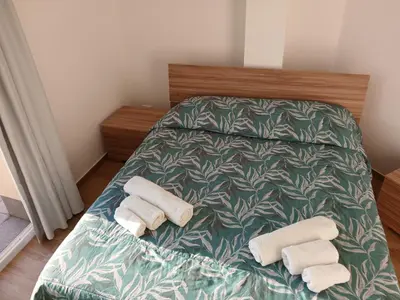 a bedroom with a bed with towels on it at HolidayHouse Belvedere in Terrasini