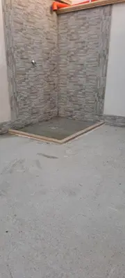 a garage with a brick wall and a door at Perla del Mare in Trappeto