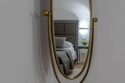 a bedroom with a bed and a mirror at MennulaMia in Palermo