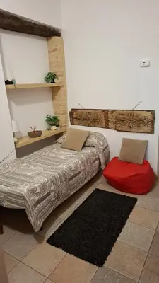 a bedroom with a bed and a red pillow at Ballarò room in Palermo