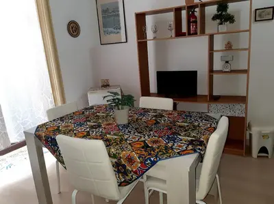 a dining room table with a colorful table cloth on it at Ballarò room in Palermo