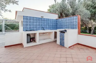 a house with a blue and white tile wall at Grande e Luminosa Villa con Piscina vicino al Mare in Terrasini