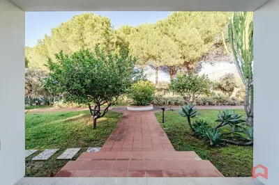 a brick walkway in a park with trees at Grande e Luminosa Villa con Piscina vicino al Mare in Terrasini