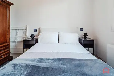 a bedroom with a large bed with two night stands at Grande e Luminosa Villa con Piscina vicino al Mare in Terrasini