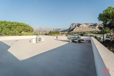 a picnic table on the roof of a house at Grande e Luminosa Villa con Piscina vicino al Mare in Terrasini