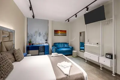 a bedroom with a large bed and a blue couch at D'ossuna66 Classic in Palermo