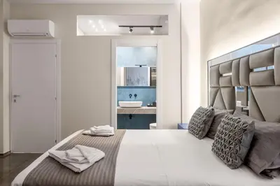 a bedroom with a large bed and a bathroom at D'ossuna66 Classic in Palermo