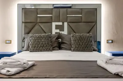 a bedroom with a large bed with a large headboard at D'ossuna66 Classic in Palermo