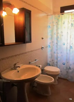 a bathroom with a sink and a toilet and a shower at Oasi del Sole - sun and sea -Casa Colombo in San Vito lo Capo