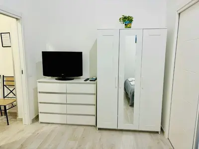 a living room with a tv and a white cabinet at MaxMondello in Palermo