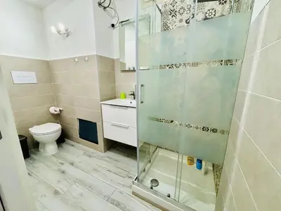 a bathroom with a shower and a toilet at MaxMondello in Palermo