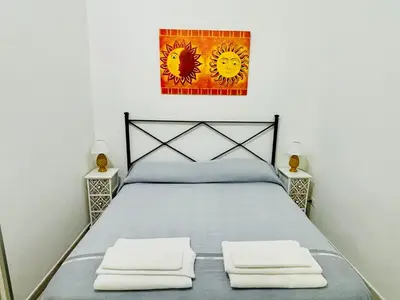 a bedroom with a bed with two night stands at MaxMondello in Palermo