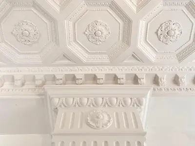 a white room with a white ceiling with ornate detailing at Villa di Nera boutique villa in Palermo