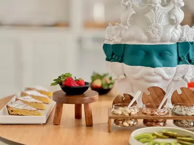 a table with a cake and a bunch of food at Villa di Nera boutique villa in Palermo