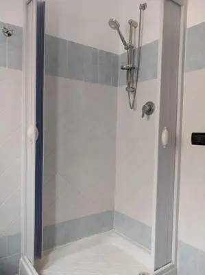 a shower with a glass door in a bathroom at Piliero room in Palermo