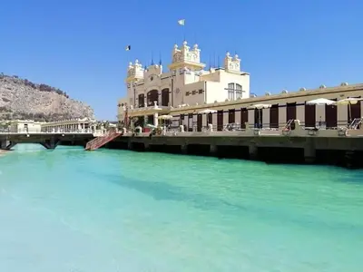 a building next to a body of water at Suite Vicino al Mare in Carini