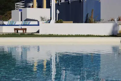 a bench sitting next to a pool of water at Casa Azul in Castellammare del Golfo