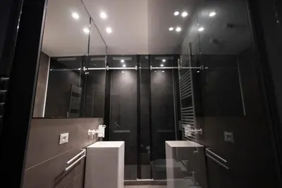 a bathroom with a sink and a glass shower at La Mia Terra Boutique Rooms in Palermo
