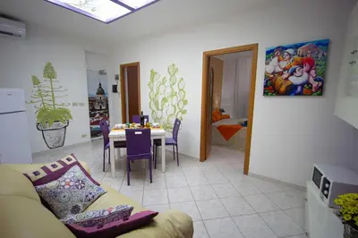 a living room with a couch and a table at My House Holiday Apartment in Palermo