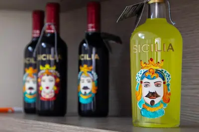 a group of three bottles of wine with dolls on them at My House Holiday Apartment in Palermo