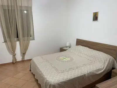 a bedroom with a bed and a window at Casa Vacanze Corale in Palermo