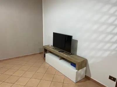 a flat screen tv sitting on a stand in a room at Casa Vacanze Corale in Palermo