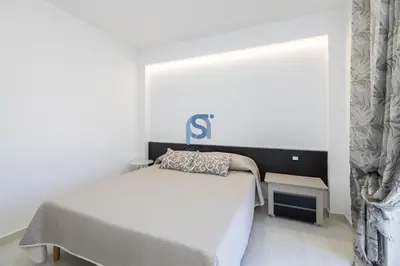 a bedroom with a bed and a sign on the wall at Villa Irene Deluxe in Campofelice di Roccella