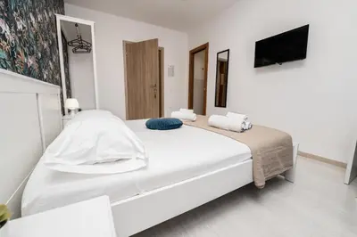 a white bedroom with a large white bed at Central Room 128L in Palermo