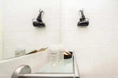a bathroom with a sink and a mirror and lights at Central Room 128L in Palermo