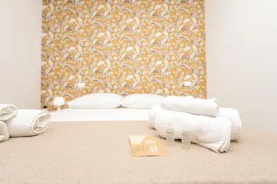 a white bed with towels and a tray on a carpet at Central Room 128L in Palermo