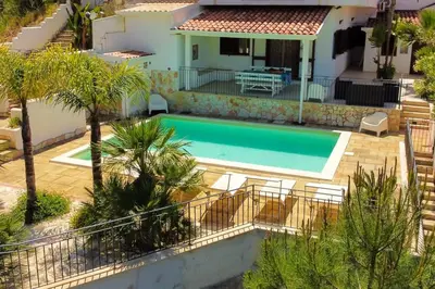 a villa with a swimming pool in front of a house at Villa con Piscina 150mt dal Mare 8 Posti OA in Alcamo