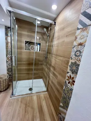 a shower with a glass door in a bathroom at Kensia house - centro storico - stazione in Palermo