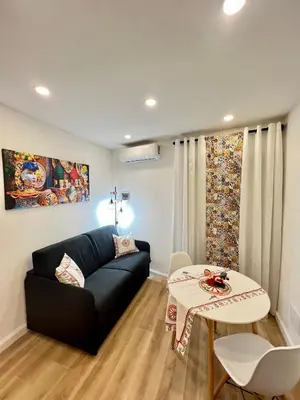 a living room with a couch and a table at Kensia house - centro storico - stazione in Palermo