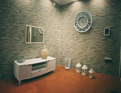 a room with a clock on a brick wall at Marrakech Home in Palermo