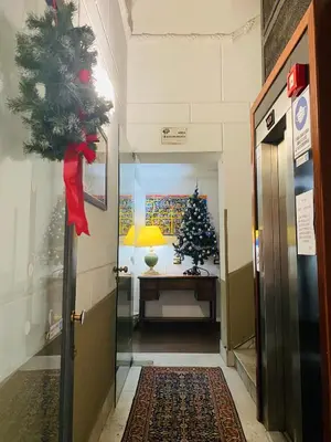 a hallway with a christmas tree in a room at Politeama House in Palermo