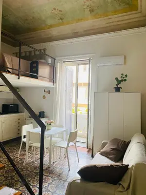 a living room with a bunk bed and a table at Politeama House in Palermo